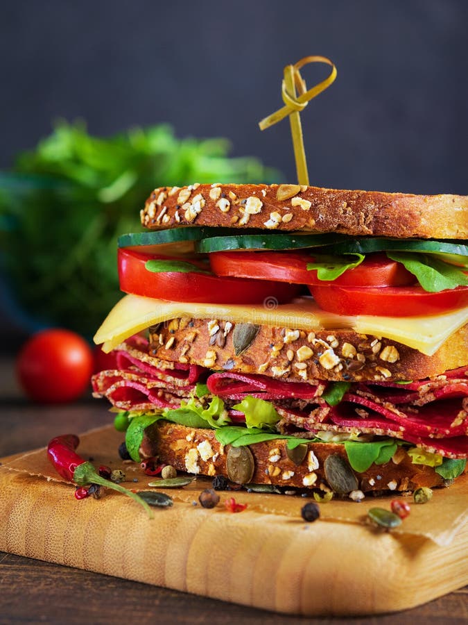 Close-up of delicious Sandwich with salami, cheese and fresh vegetables