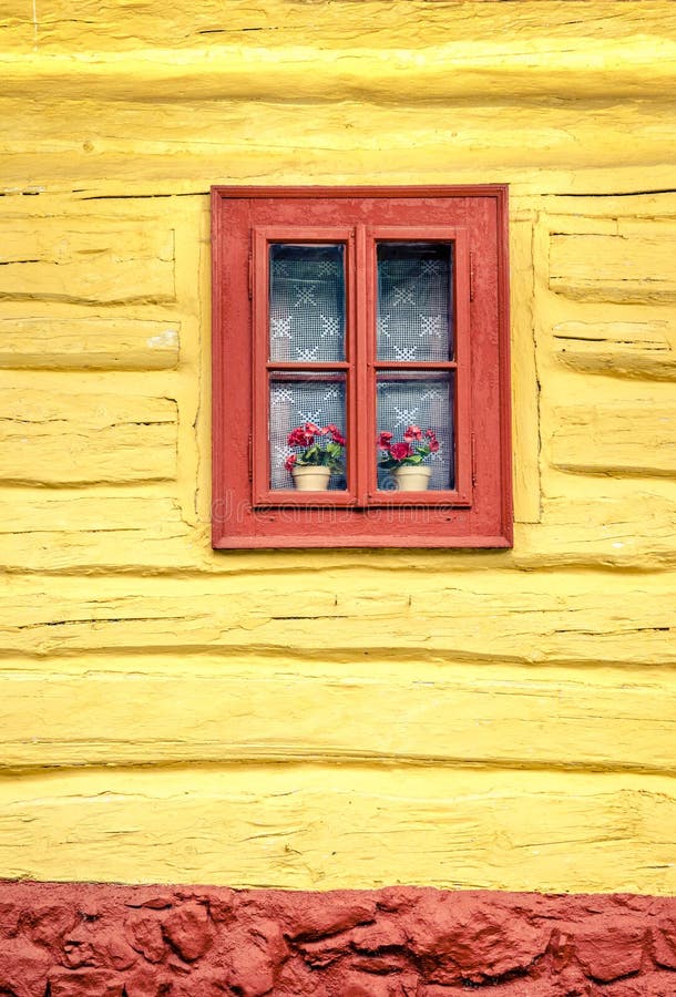 Close-up detail of colorful window on wooden cottage