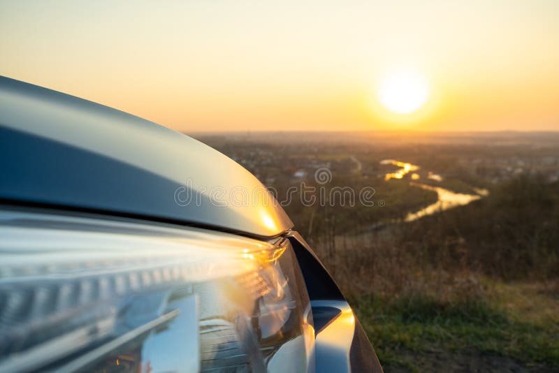 Close Up Detail of Front Headlight Lamp of Modern Car at Sunset Stock
