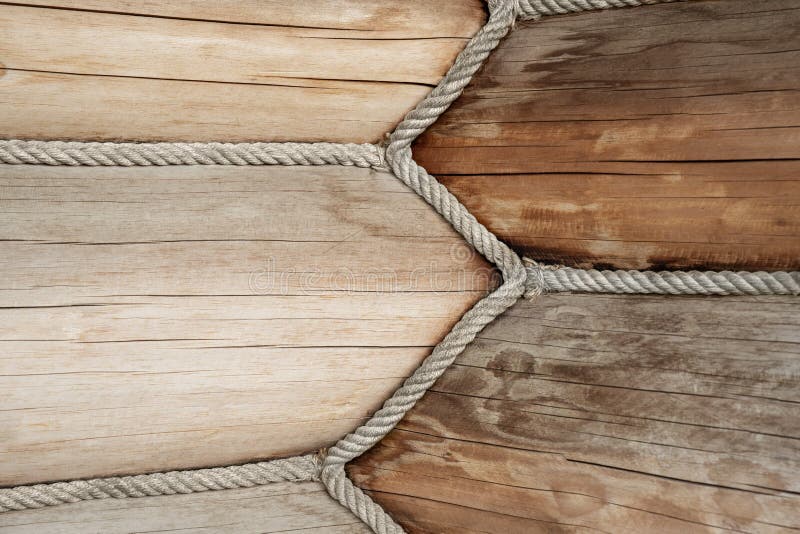 Close-up detail view of wooden log building corner joint decorated with jute rope isolation sealant. Timber beam wall