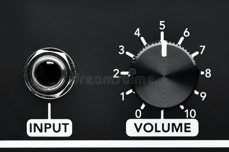Close up detail of volume control knob and input jack of a black guitar amplifier stock photo