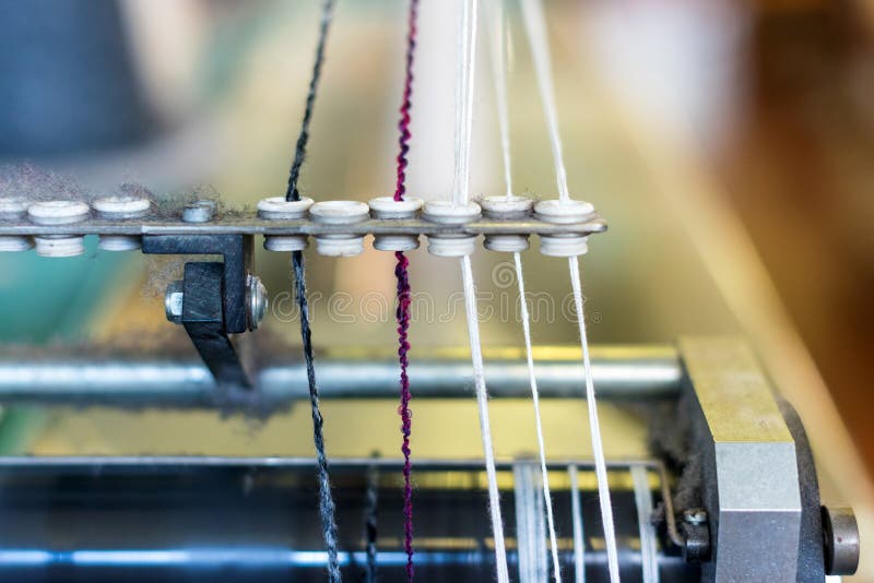 Close Up Detail on a Yarn Feeder on Commercial Knitting Machine Stock