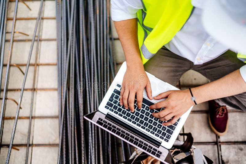 Details of Engineer Working on Laptop on Construction Site Stock Image