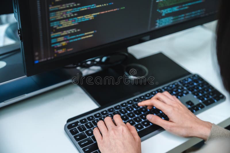 Close up developer hand coding with keyboard on desk at modern office stock photography