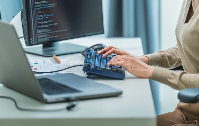 Close up developer hand coding with keyboard on desk at modern office stock image