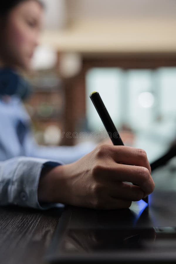 Close up of digital photo editor sitting at desk with multiple displays while using editing software royalty free stock photo