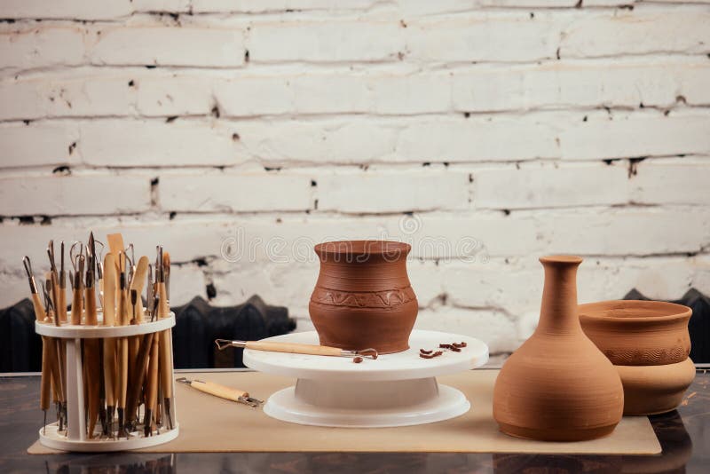 Close up dirty hands of a man woman potter, creating an clay earthen jar pot on the potter`s wheel circle in the stock images Close up dirty hands of a man woman potter, creating an clay earthen jar pot on the potter`s wheel circle in the stock images