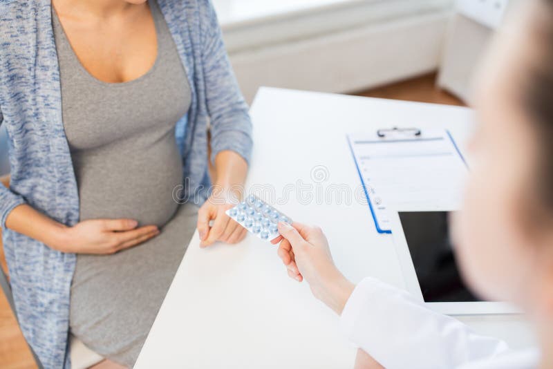 Close up of doctor giving pills to pregnant woman royalty free stock photos Close up of doctor giving pills to pregnant woman royalty free stock photos