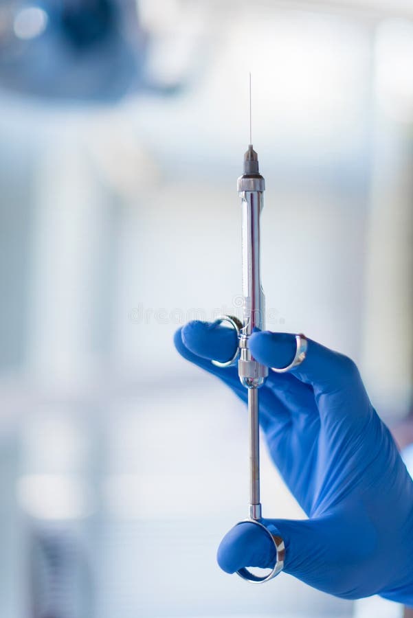 Close up of doctor holding syringe with dental anesthetic.