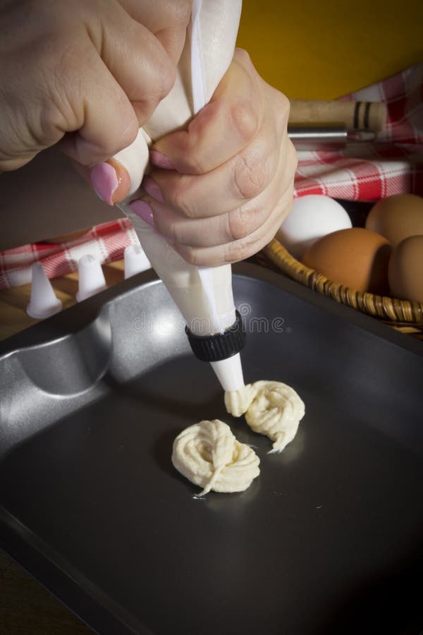 Closeup of Dough from Pastry Bag on Baking Sheet Stock Photo Image