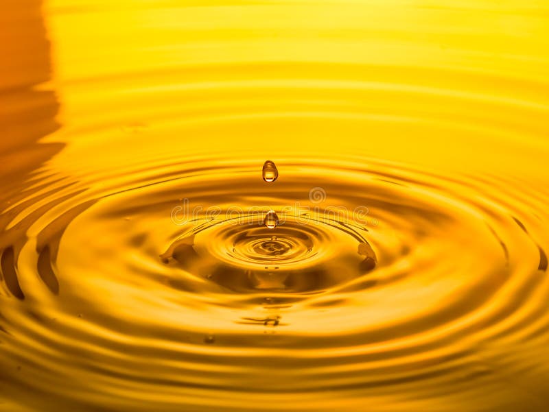 Close Up of a Drop Oil on a Yellow Background Stock Image - Image of ...