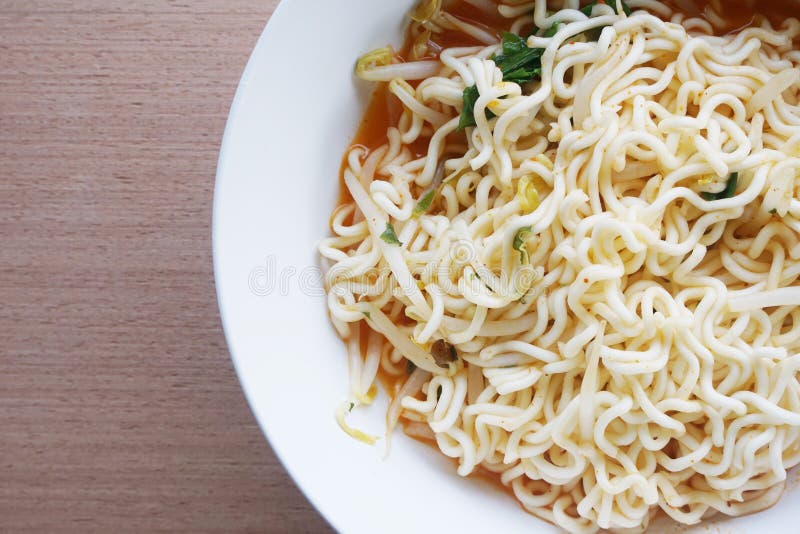 Close up dry tomyum noodle on wooden table