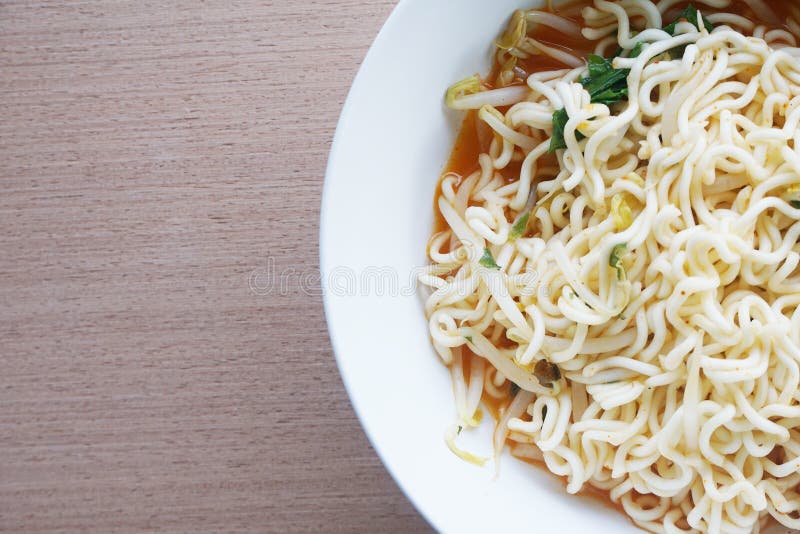 Close up dry tomyum noodle on wooden table