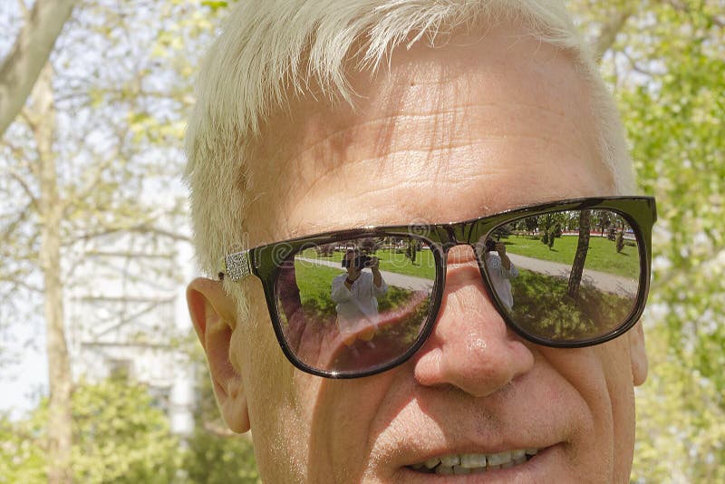 Close-up of an elderly gray-haired man in mirrored sunglasses . royalty free stock photos Close-up of an elderly gray-haired man in mirrored sunglasses . royalty free stock photos