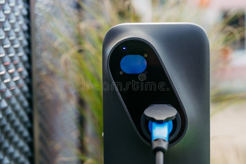 Close Up Electric Car Charging Station in Front of Office Building. Charging at Work, Workplace