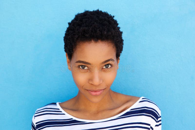 Close up elegant young african woman against blue background royalty free stock photo Close up elegant young african woman against blue background royalty free stock photo