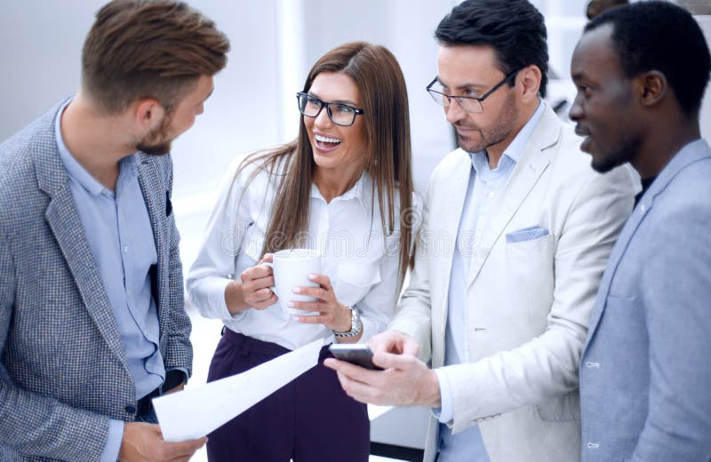 Close up.employees discuss something standing in the office stock photos Close up.employees discuss something standing in the office stock photos