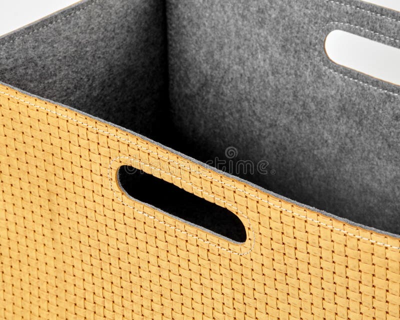 Empty yellow woven storage box with grey felt lining stock images