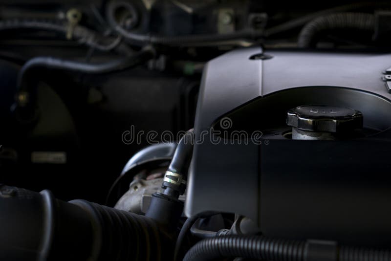 Closeup on Engine Oil Cap of the Car. with Blurred Image of Elements on the Side of the Engine