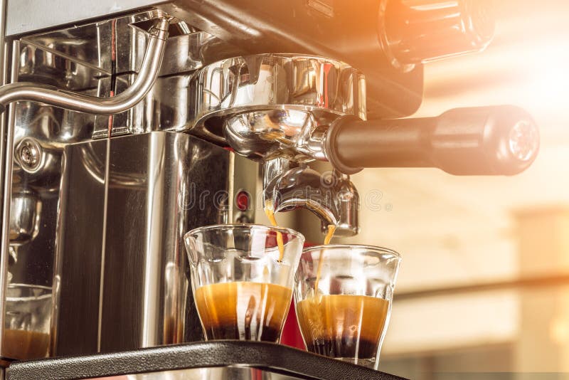 Close-up of espresso pouring from coffee machine at the morning