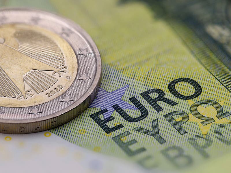 Close up of euro banknote with coin, selective focus on the word EURO royalty free stock images