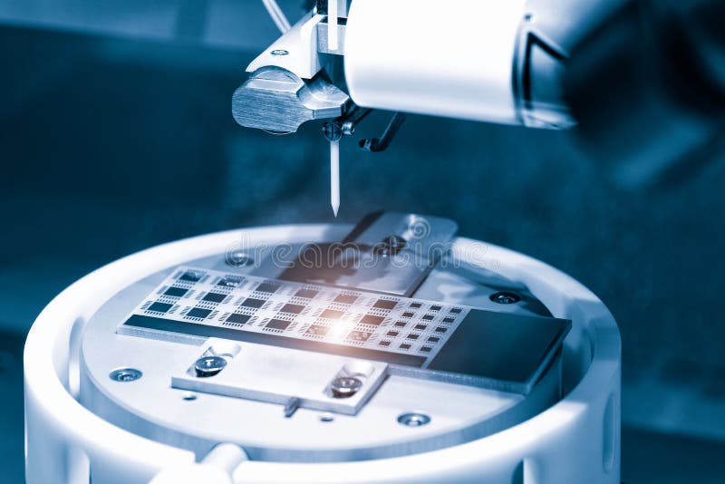 Close up of examining of test sample of microchip transistor under the microscope in laboratory. Equipment for testing microchips. royalty free stock photography