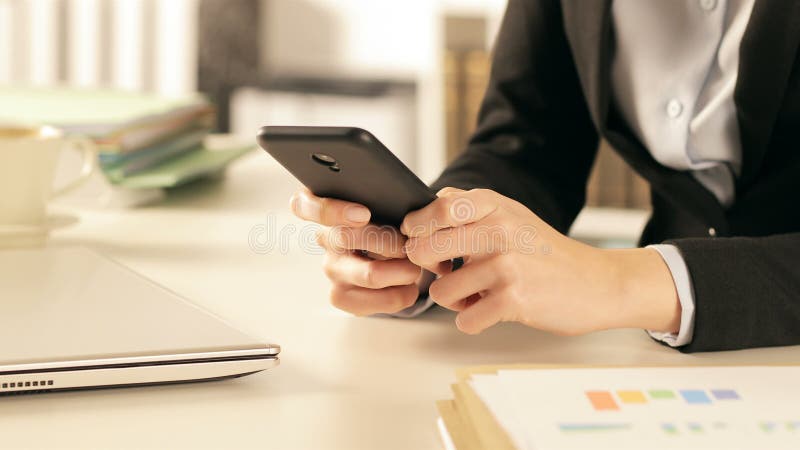 Executive hands using smart phone at office