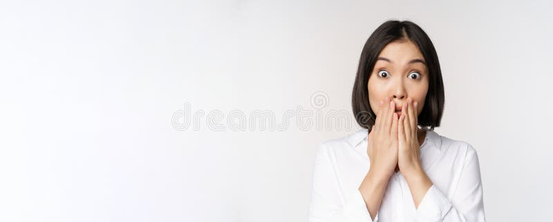Close Up Face Of Asian Woman Gasping Looking Shocked And Speechless