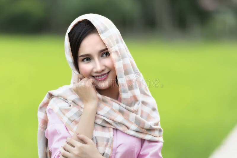 Close up face of beautiful Lao woman wearing local tradition on green rice field. royalty free stock photos Close up face of beautiful Lao woman wearing local tradition on green rice field. royalty free stock photos