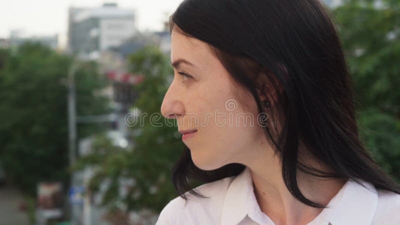 Close-up face of happy successful adult business woman looking away in city stock video Close-up face of happy successful adult business woman looking away in city stock video