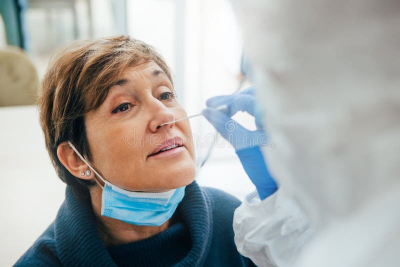 Close up of the face of a senior female patient being tested for Covid-19