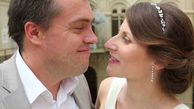 Close-up faces of beautiful bride and groom in the stock video footage