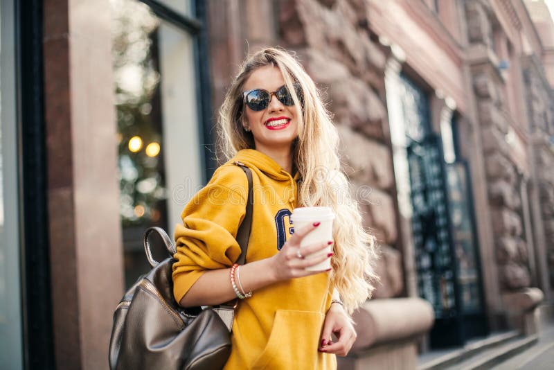 Close up fashion street stile portrait of pretty girl in fall casual outfit Beautiful blond posing outdoor.