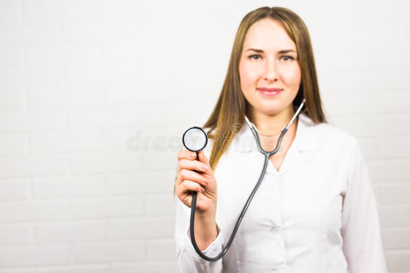 Closeup of Female Doctor Using Stethoscope , Focus on Stethoscope