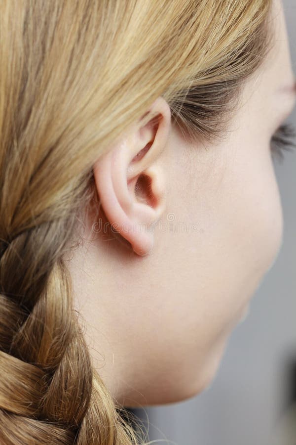 Close up on female ear and braid hair