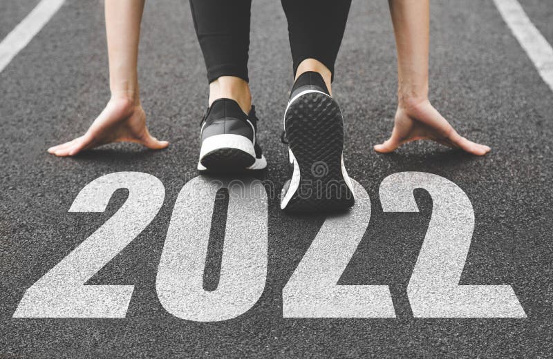 Close-up of female feet in sneakers at the start. Beginning and start of the new year 2022, goals and plans for the next. Year