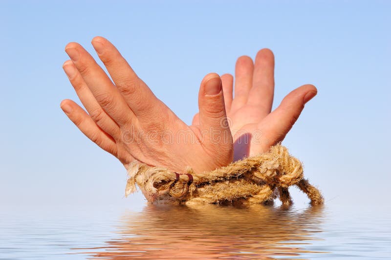 Close up of female hands tied in a rope