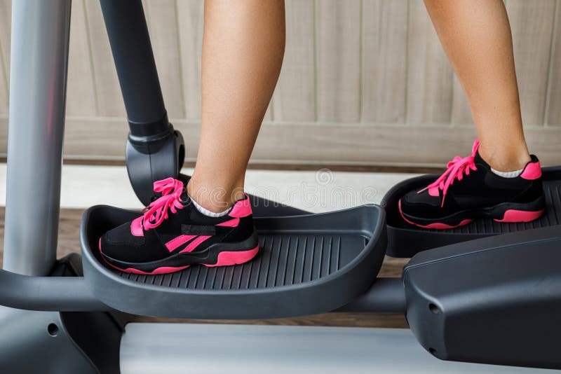 Female Legs on a Elliptical Trainer in the Gym Stock Image Image of