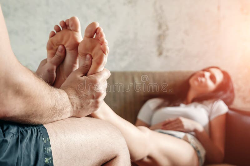 Close-up of Female Legs Receiving a Foot Massage from Her Husband