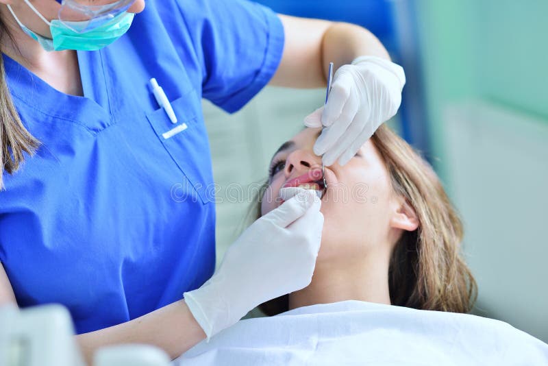 Close Up Of Female With Open Mouth During Oral Checkup At The Dentist