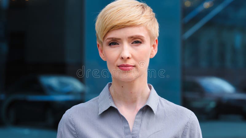 Close-up female serious face headshot portrait outdoors caucasian middle aged business woman boss blonde short haired