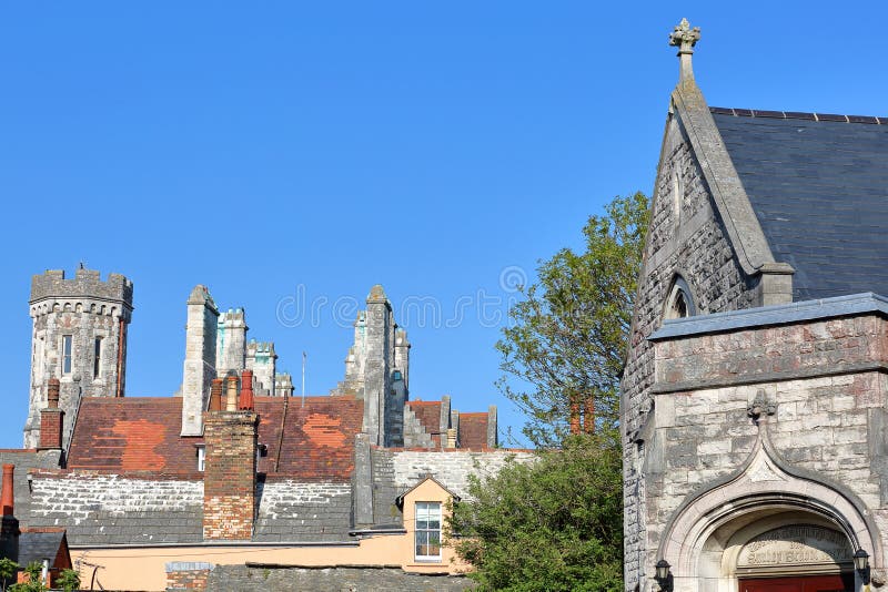 Close-up on flagstone roofs with Swanage Methodist Church on the right side and the Victorian building Purbeck House Hotel in the