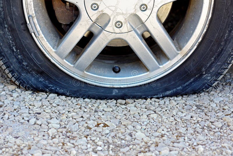 Close Up On Flat Car Tire On Gravel Road Stock Image - Image: 39601161