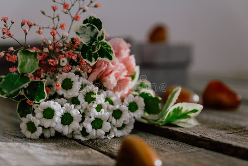 Close up Flower bouquet with gift box and stone on wood background. Can be used for wedding, mother day, valentine stock photo Close up Flower bouquet with gift box and stone on wood background. Can be used for wedding, mother day, valentine stock photo