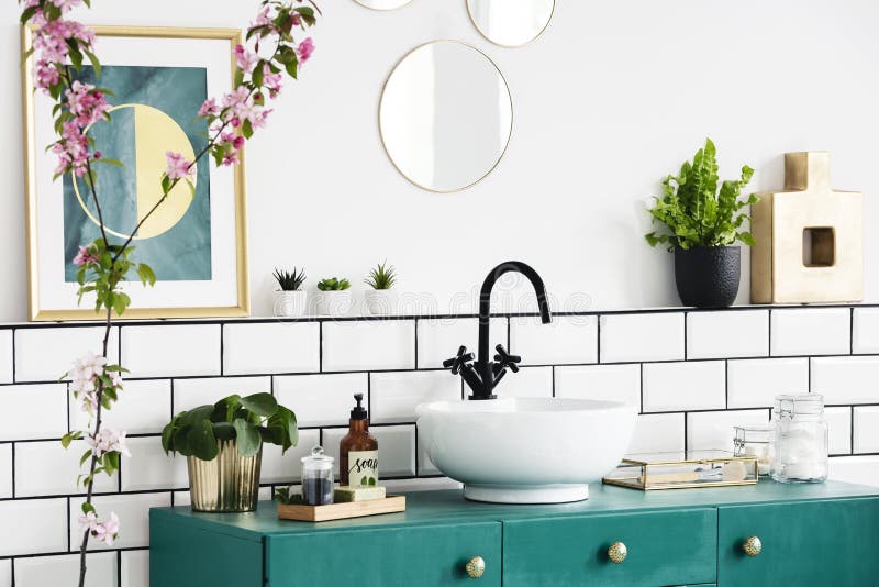 Close-up of a flower, graphic on the wall and wash basin on a turquoise cupboard. Real photo royalty free stock image Close-up of a flower, graphic on the wall and wash basin on a turquoise cupboard. Real photo royalty free stock image