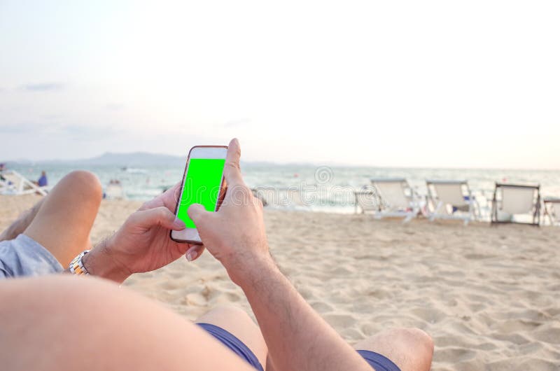 Lazy time. Man with mobile phone on a summer day royalty free stock image
