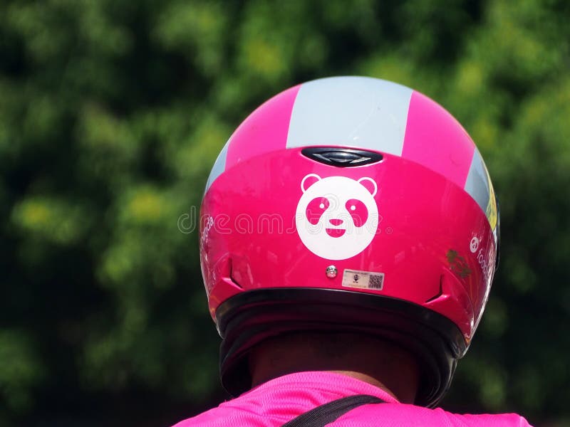 Close-up on the FoodPanda logo on the crash helmet of a FoodPanda delivery motorcyclist rider in Malaysia. Close-up on the FoodPanda logo on the crash helmet of a FoodPanda delivery motorcyclist rider in Malaysia