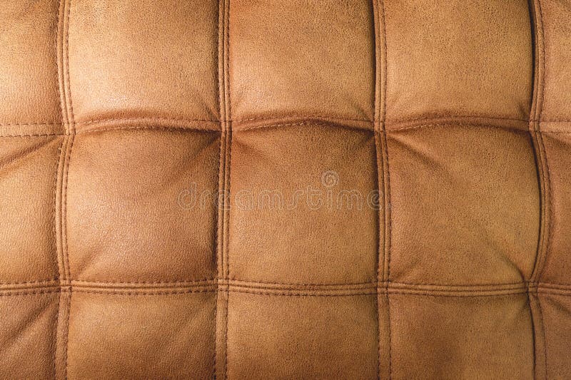 A Closeup of a Fragment of an Expensive Brown Textile Sofa in the Room