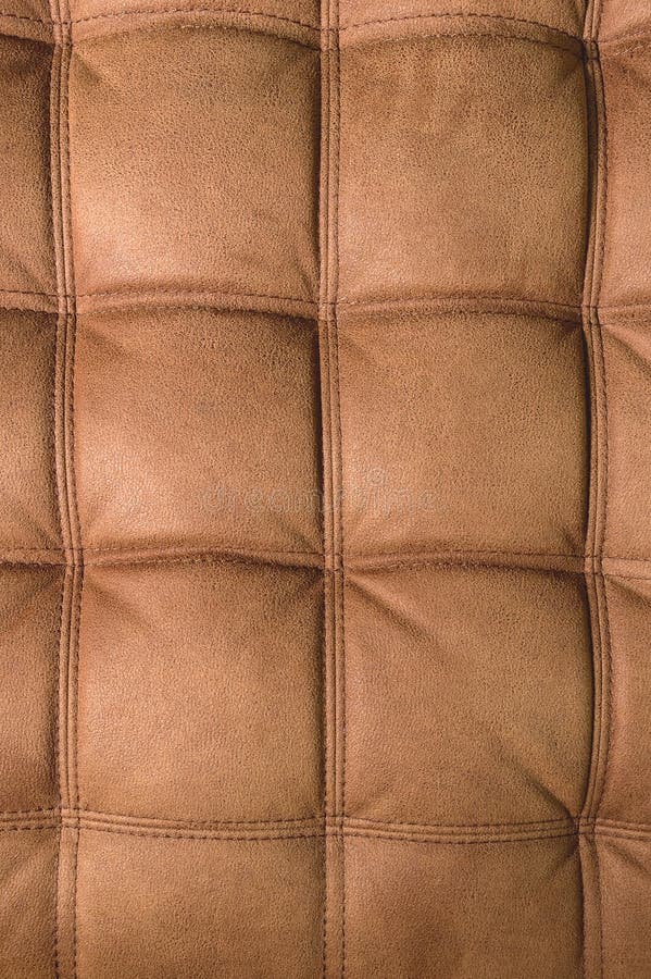 A Closeup of a Fragment of an Expensive Brown Textile Sofa in the Room