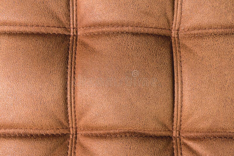 A Closeup of a Fragment of an Expensive Brown Textile Sofa in the Room